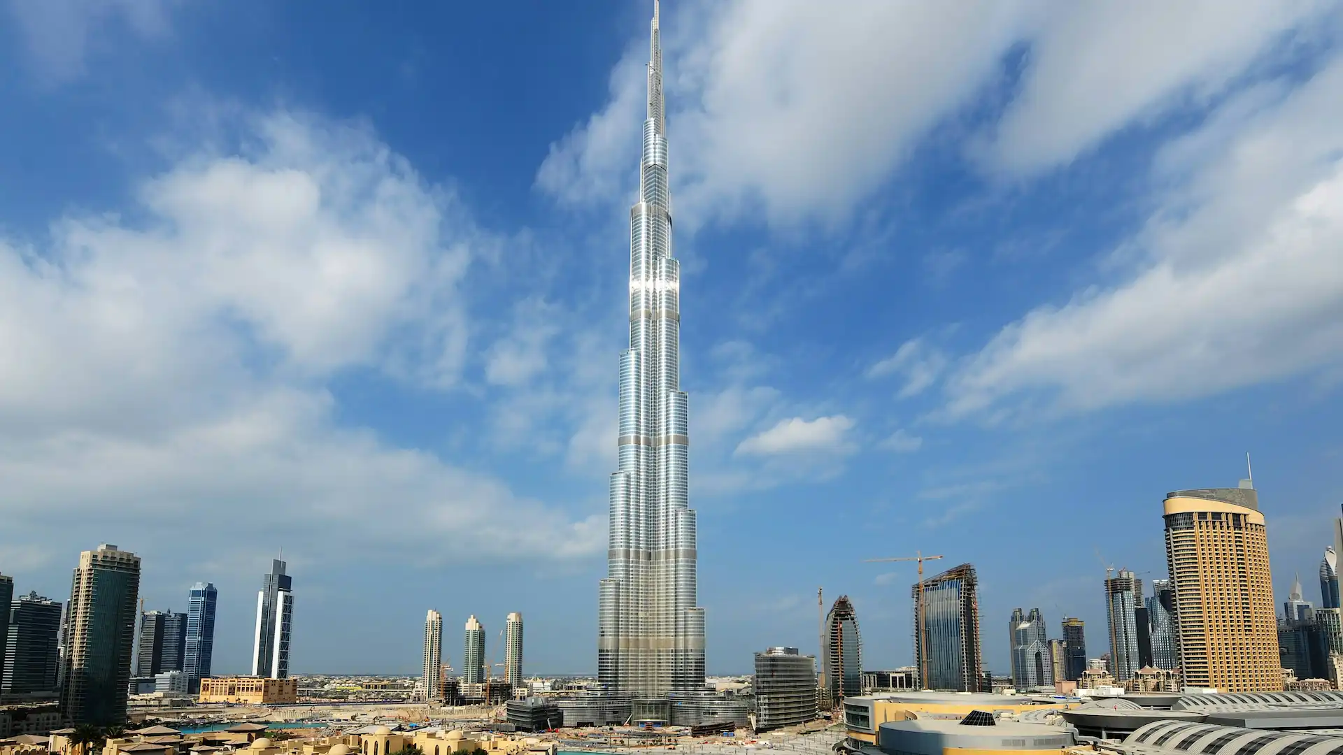 Burj Khalifa stands as the tallest building globally, offering unparalleled views from its observation decks on levels 124 and 148. It's a marvel of modern architecture and engineering, surrounded by luxurious dining and shopping options. The tower is beautifully lit at night, creating a mesmerizing skyline. A must-visit for anyone in Dubai.